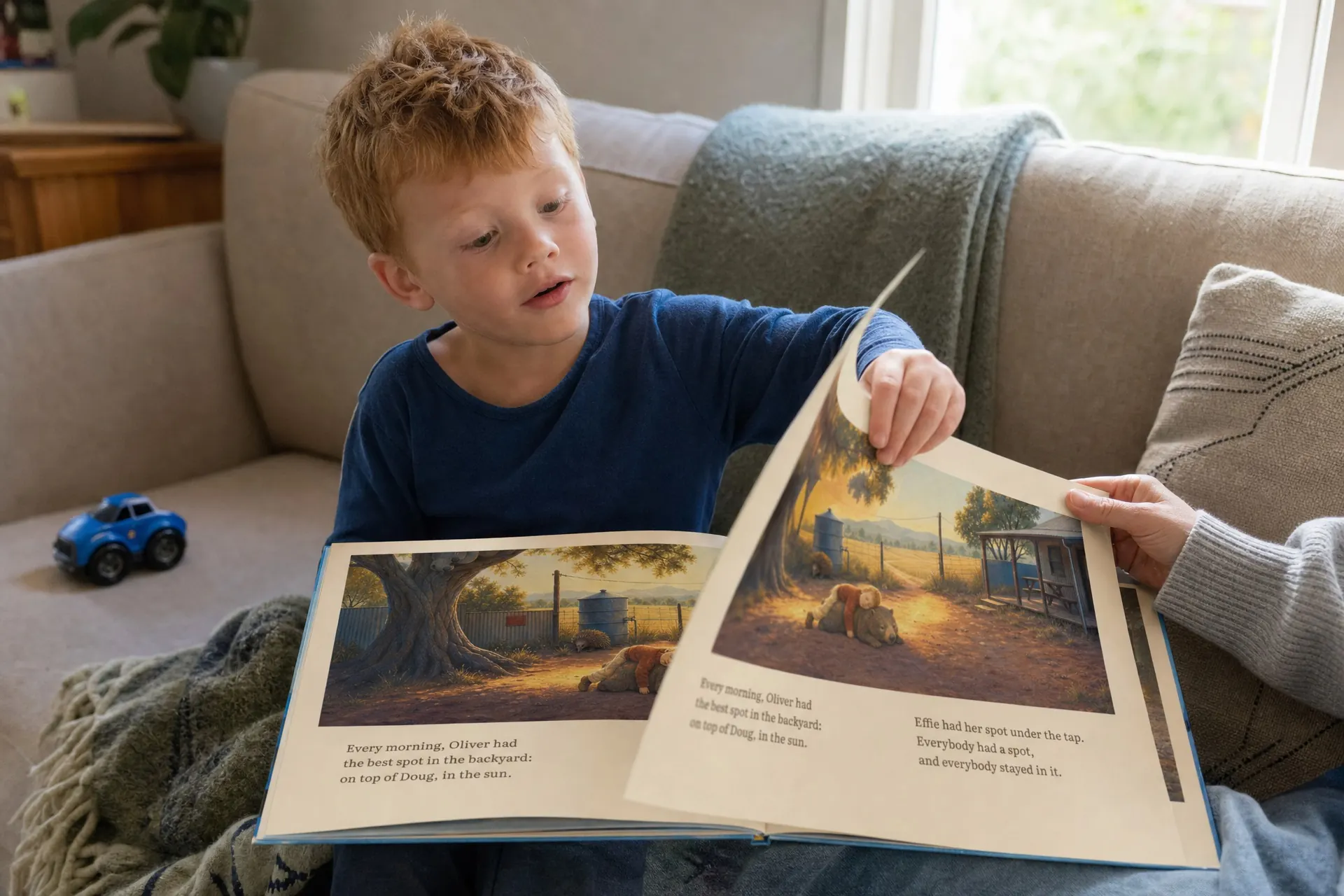 A child turning a page of a picture book.